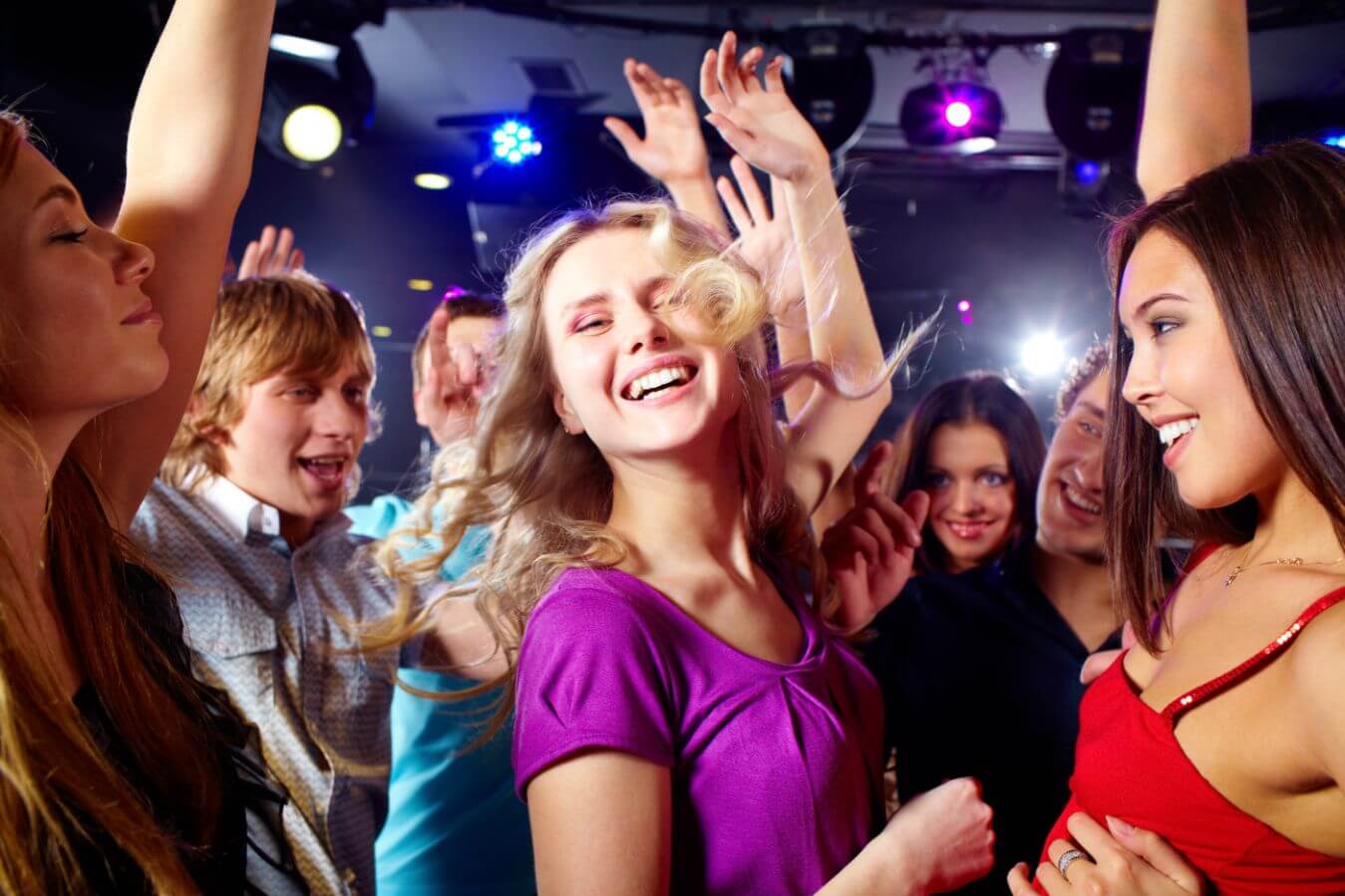 A group of young people enjoying themselves on the dance floor at a nightclub in Chicago.